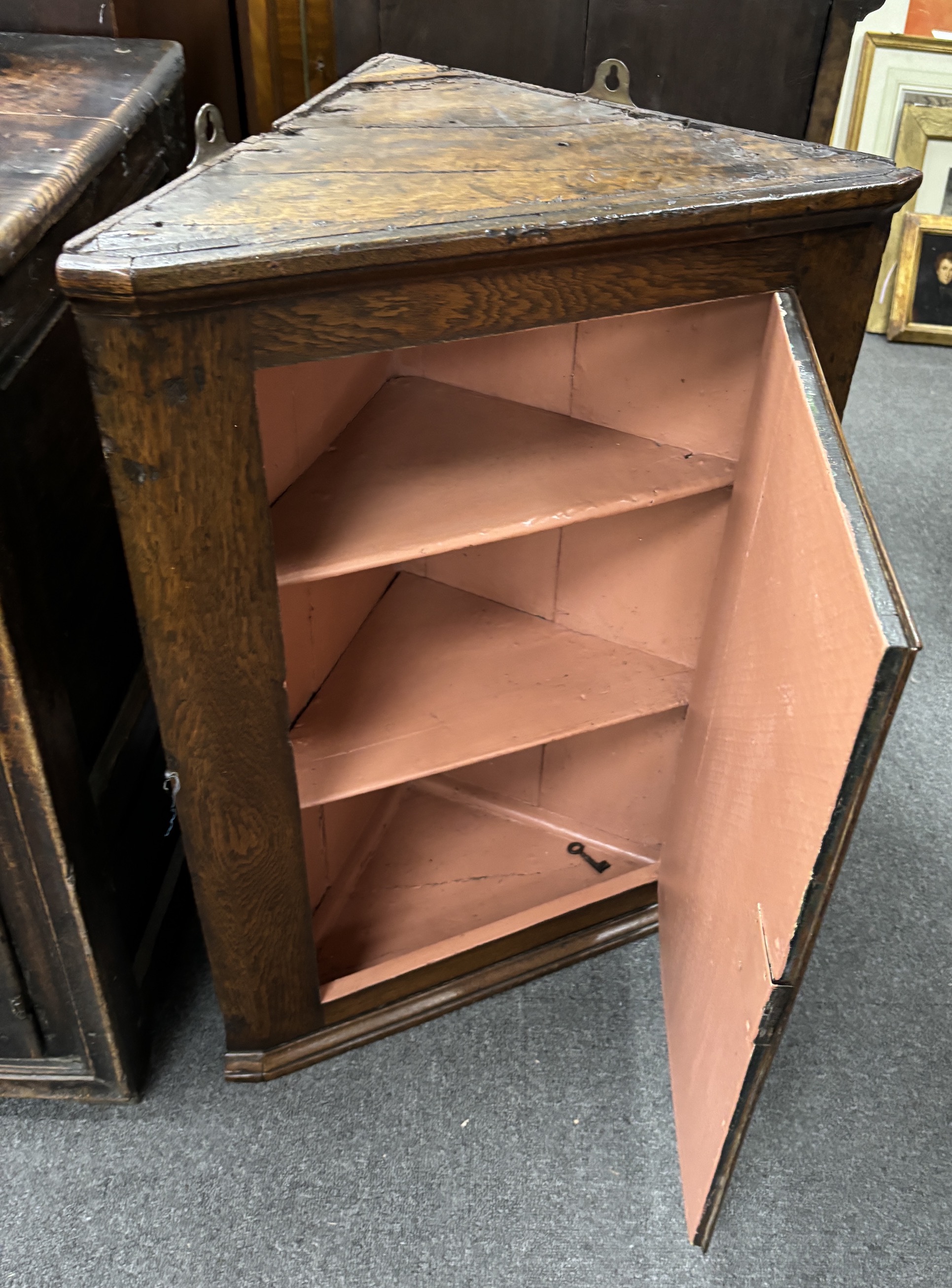 A late 18th century oak hanging corner cupboard, width 55cm, depth 30cm, height 80cm